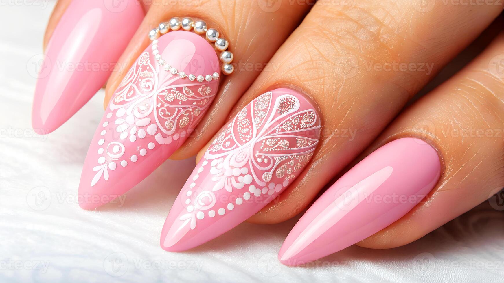 Elegant pink long nails with intricate white lace design decorated with pearls for a chic manicure look close up photo