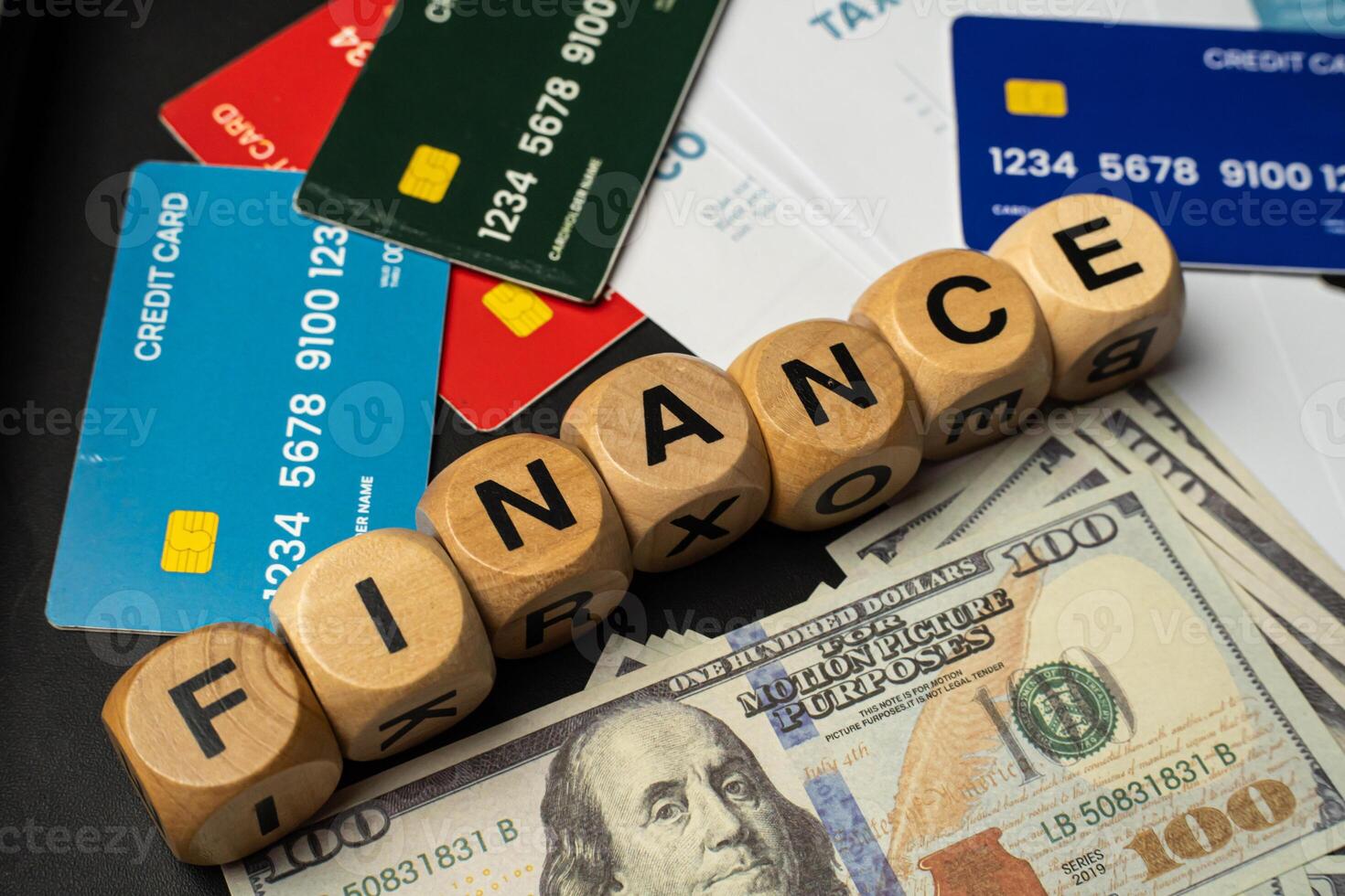Business and finance background image showing a blend of paper currency, credit cards, profit charts, tax files, and an office setup photo