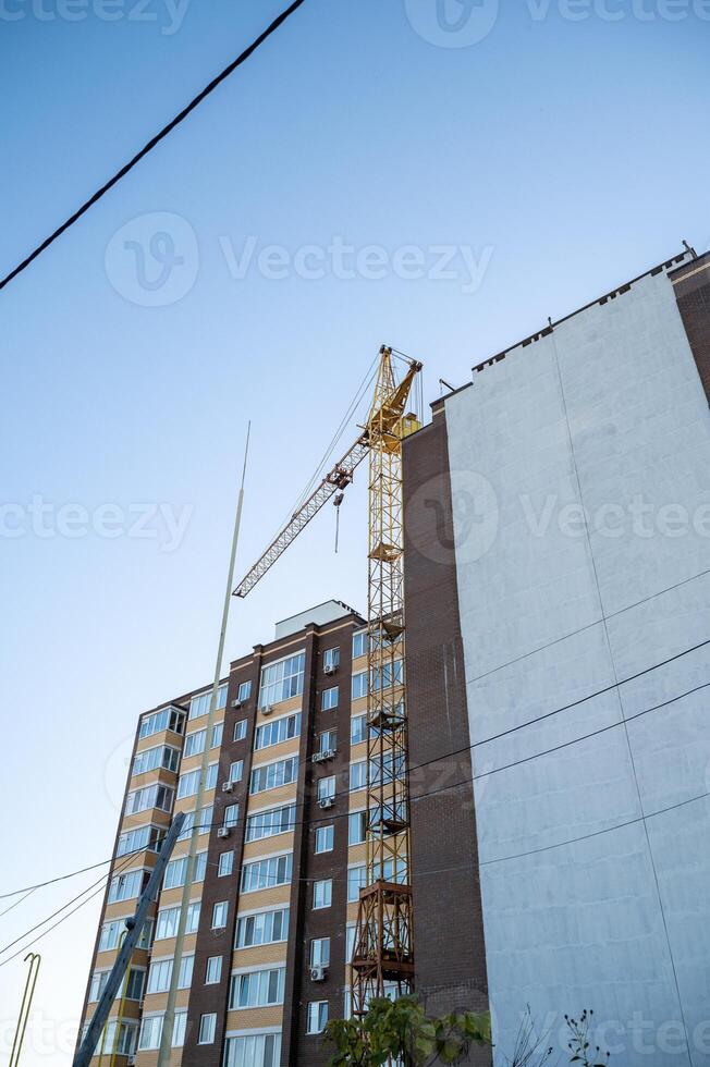 A large building with a crane on top of it photo