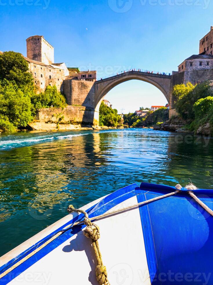 Boat ride through the Neretva with a beautiful view of the Old Bridge. The most popular tourist attractions in Bosnia and Herzegovina, Mostar city. photo