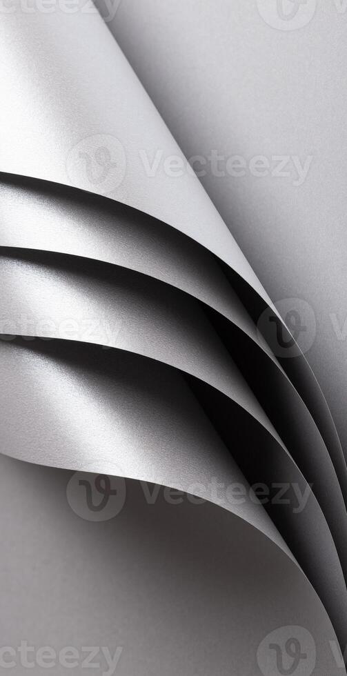 Silver and gray paper texture with metallic shine and pearlescent finish, folded and rolled design photo