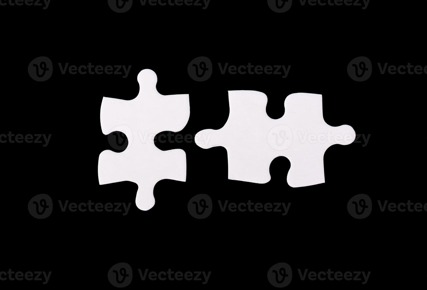 Two puzzle pieces in a business context, symbolizing collaboration, partnership, and synergy. The photo
