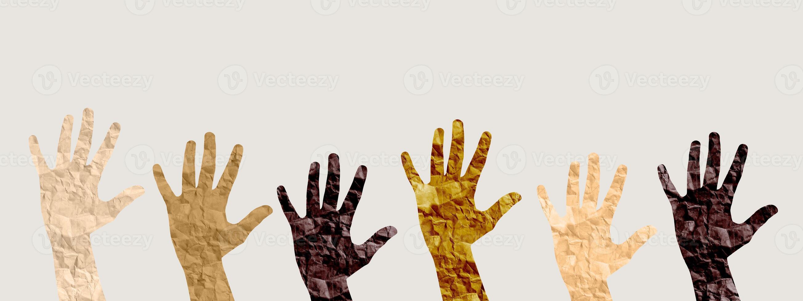Hands of diverse skin tones raised in unity, symbolizing inclusion, equality, and empowerment. This photo