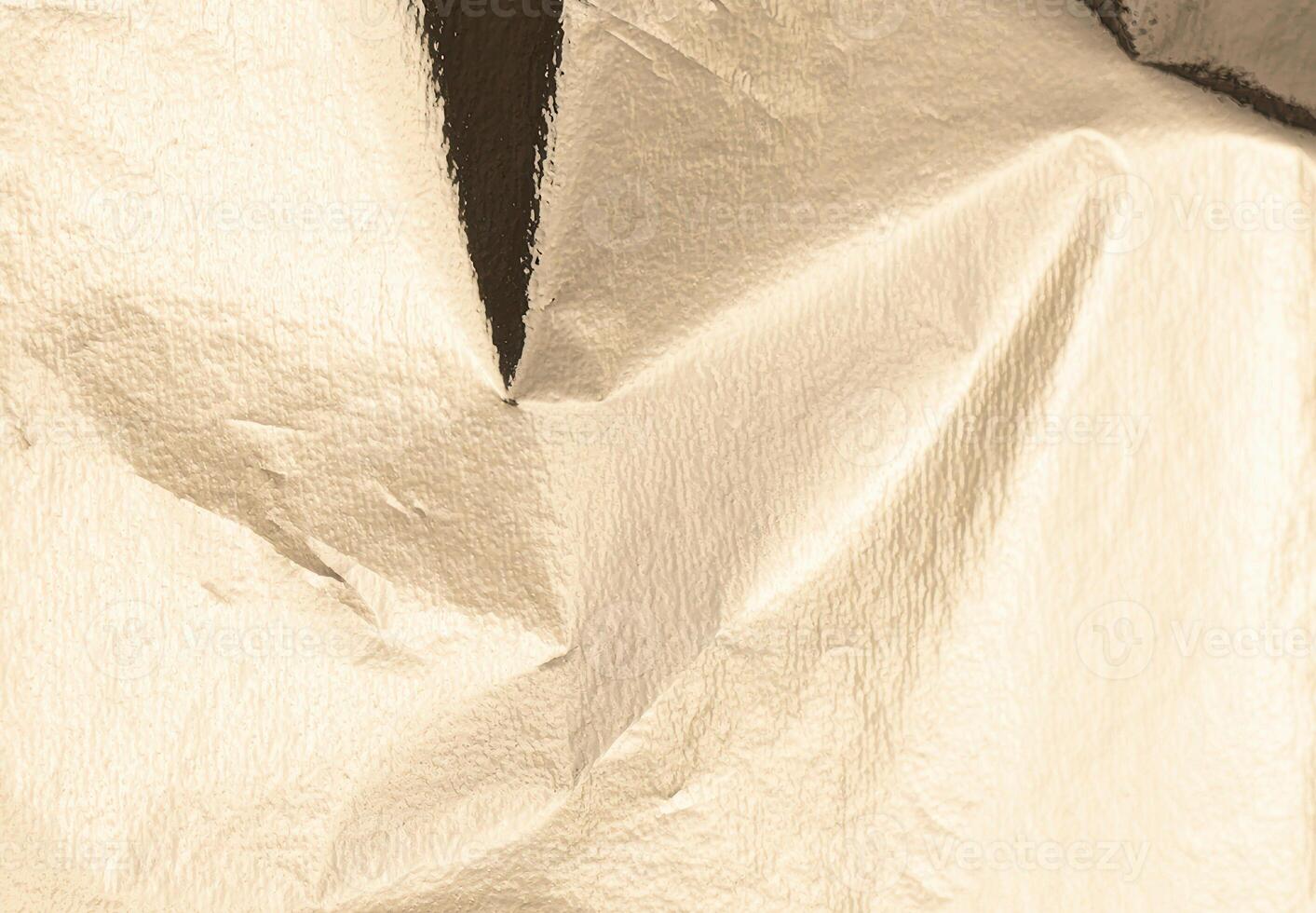Gold foil texture with a crinkled, elegant finish. Reflective, luxury alloy sheet featuring a bright photo
