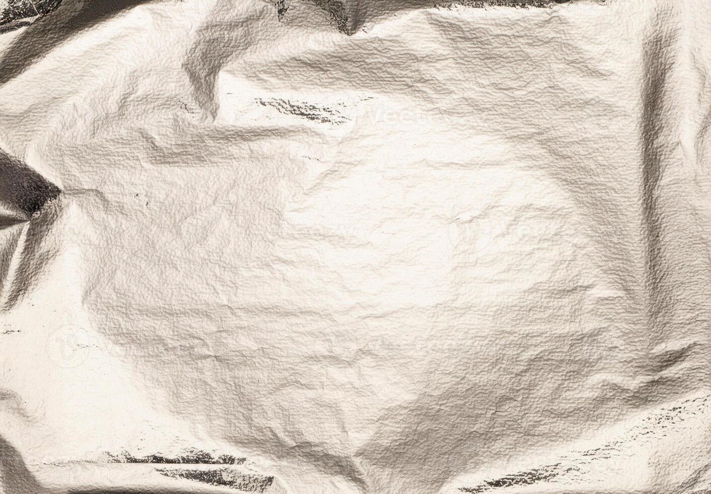 Silver foil crumpled texture with shiny, metallic surface. Smooth, reflective gloss and gradient photo