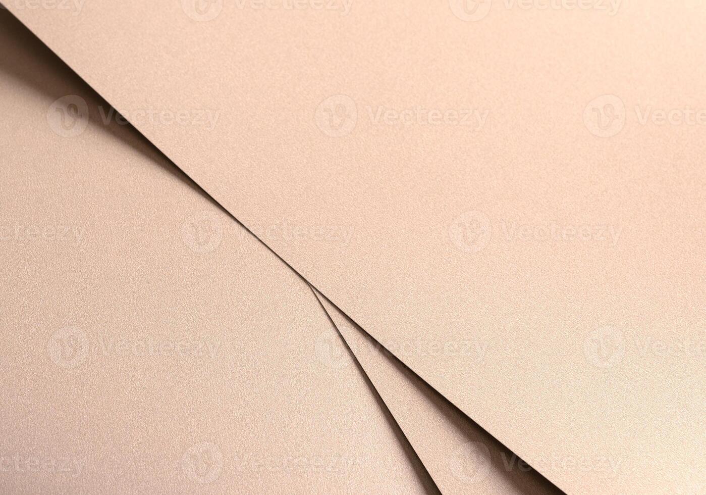 Paper texture with soft beige and light gold tones, glossy glistering surface with geometric layered photo