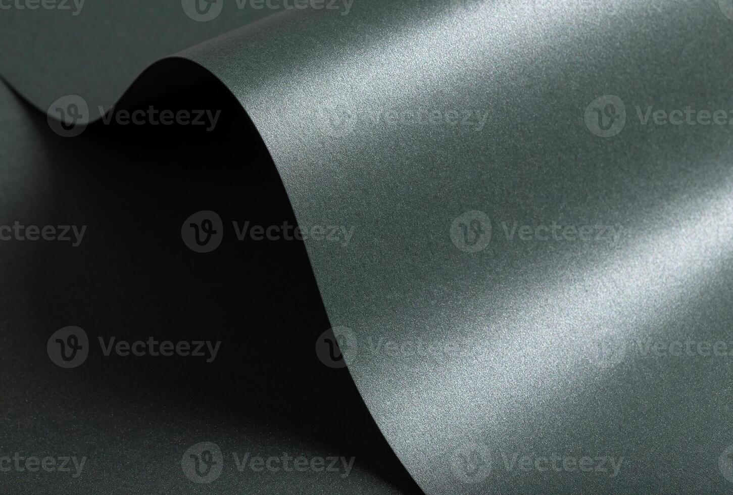 Paper texture with forest green tone, wavy glossy surface and pearlescent shimmer, elegant layered photo