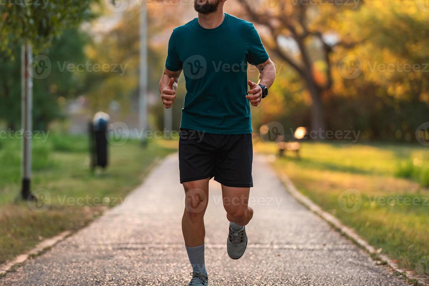 A sporty man running or jogging at the park, active healthy lifestyle. photo