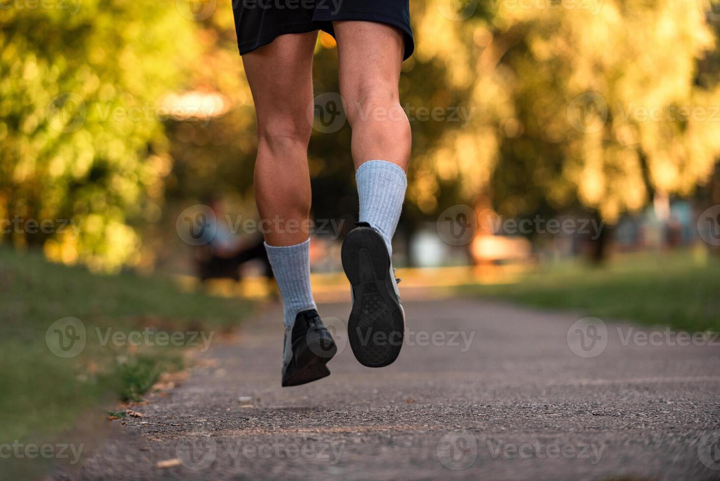 Close up of male athlete runner feet running on road, Jogging concept at outdoors. Man running for exercise. Active healthy lifestyle. photo