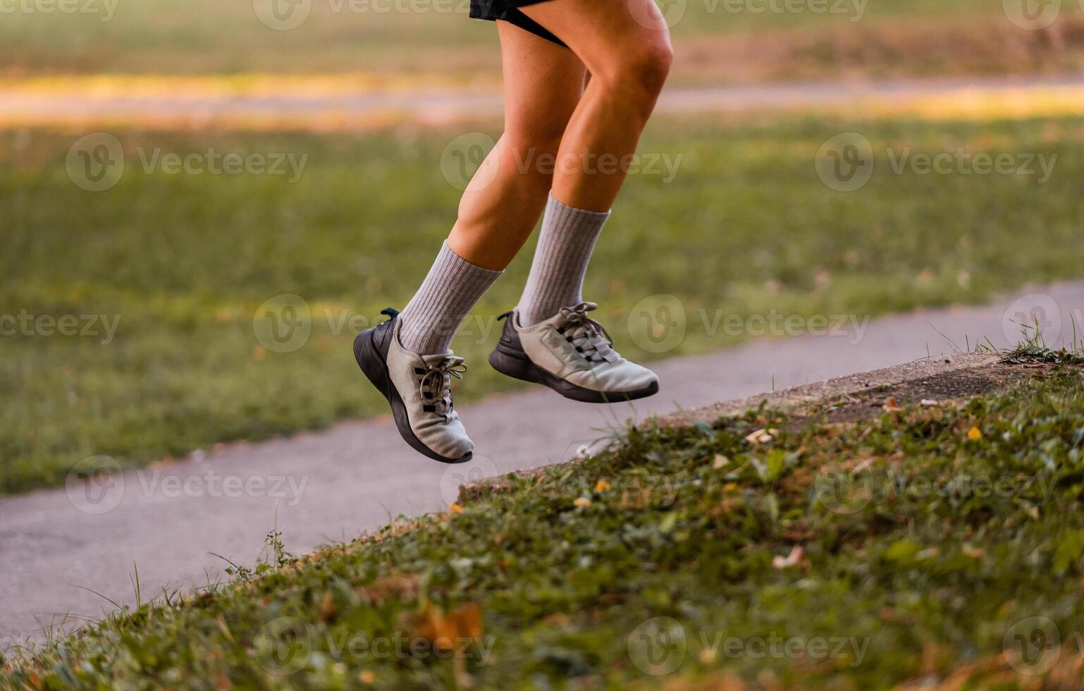 Cropped image of a sporty running man in cross country trail run. photo