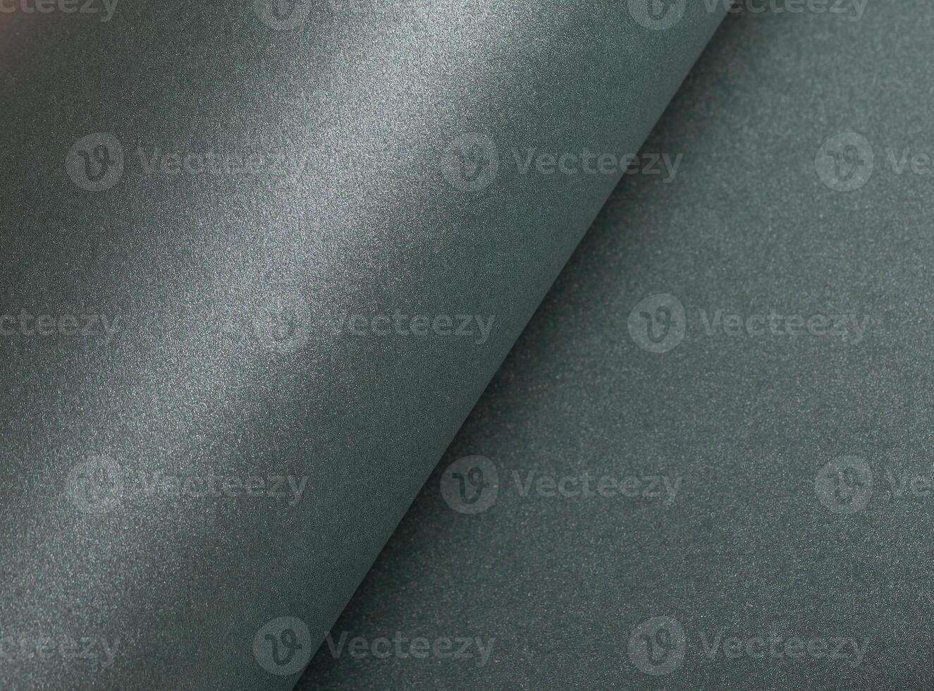 Paper texture with metallic green tone, glossy rolled surface and shimmering gloss finish, elegant photo