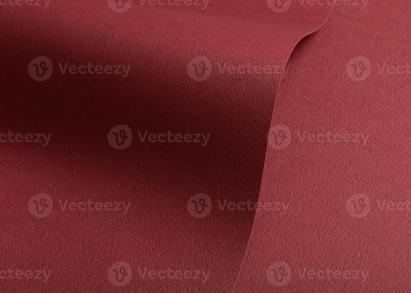 Paper texture with maroon tone, clean wavy fold and perforated surface, deep red designer paper photo