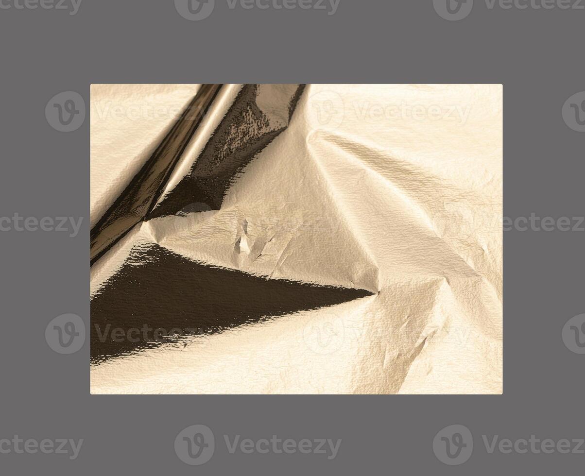 Golden rectangular shape with a polished, metallic surface creates a sleek, modern design. Wrinkled photo