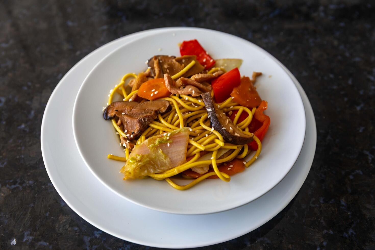 The most traditional yakissoba prepared with vegetables, noodles, pork and oriental spices. portrait photo