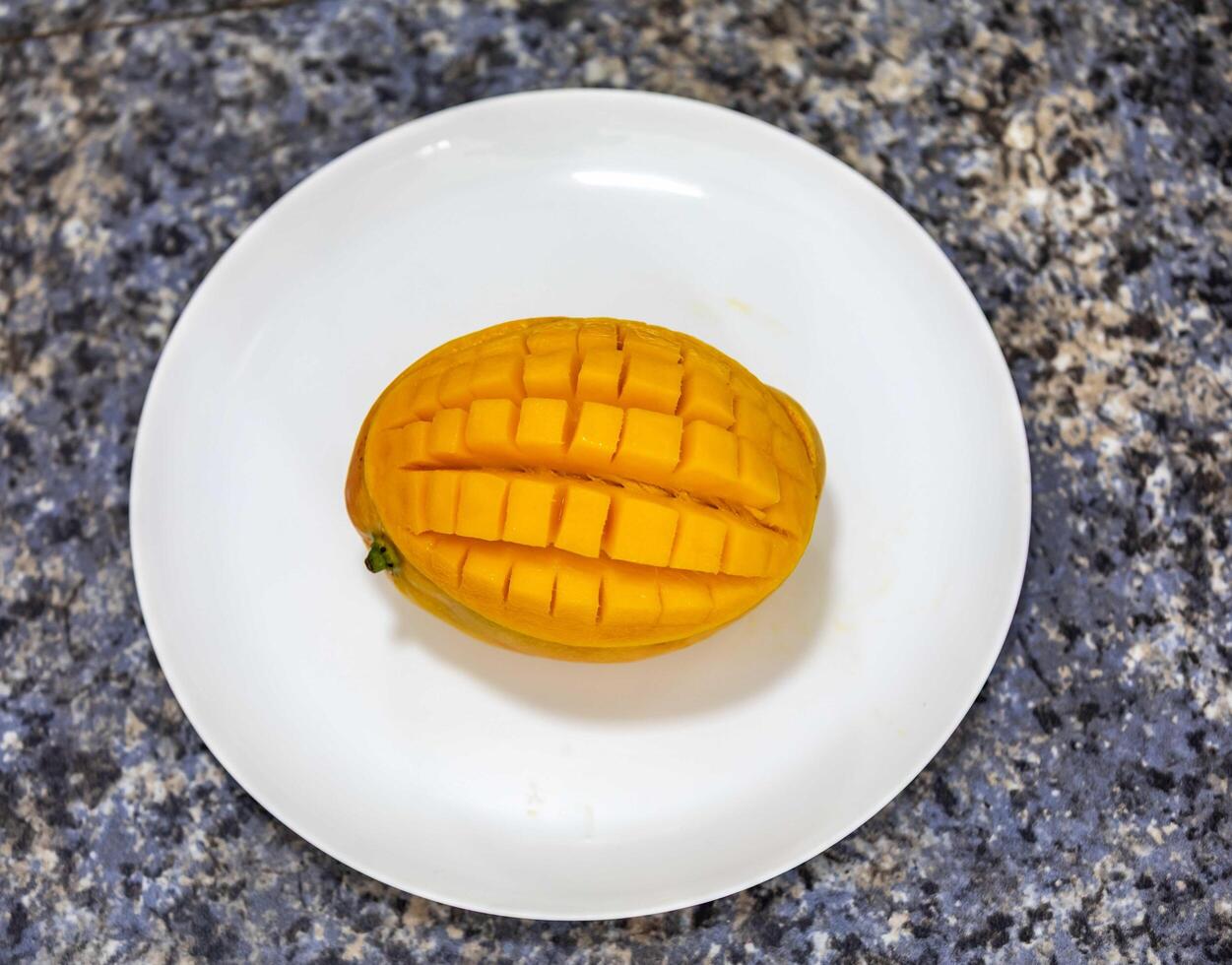 Ripe rosa mango isolated on uniform background. Brazilian fruit and food view photo