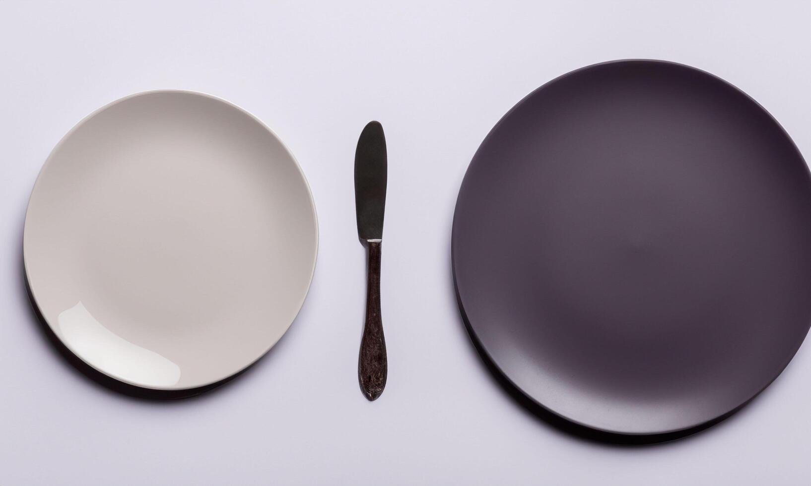Plate and cutlery isolated on plain background in top view classic photo