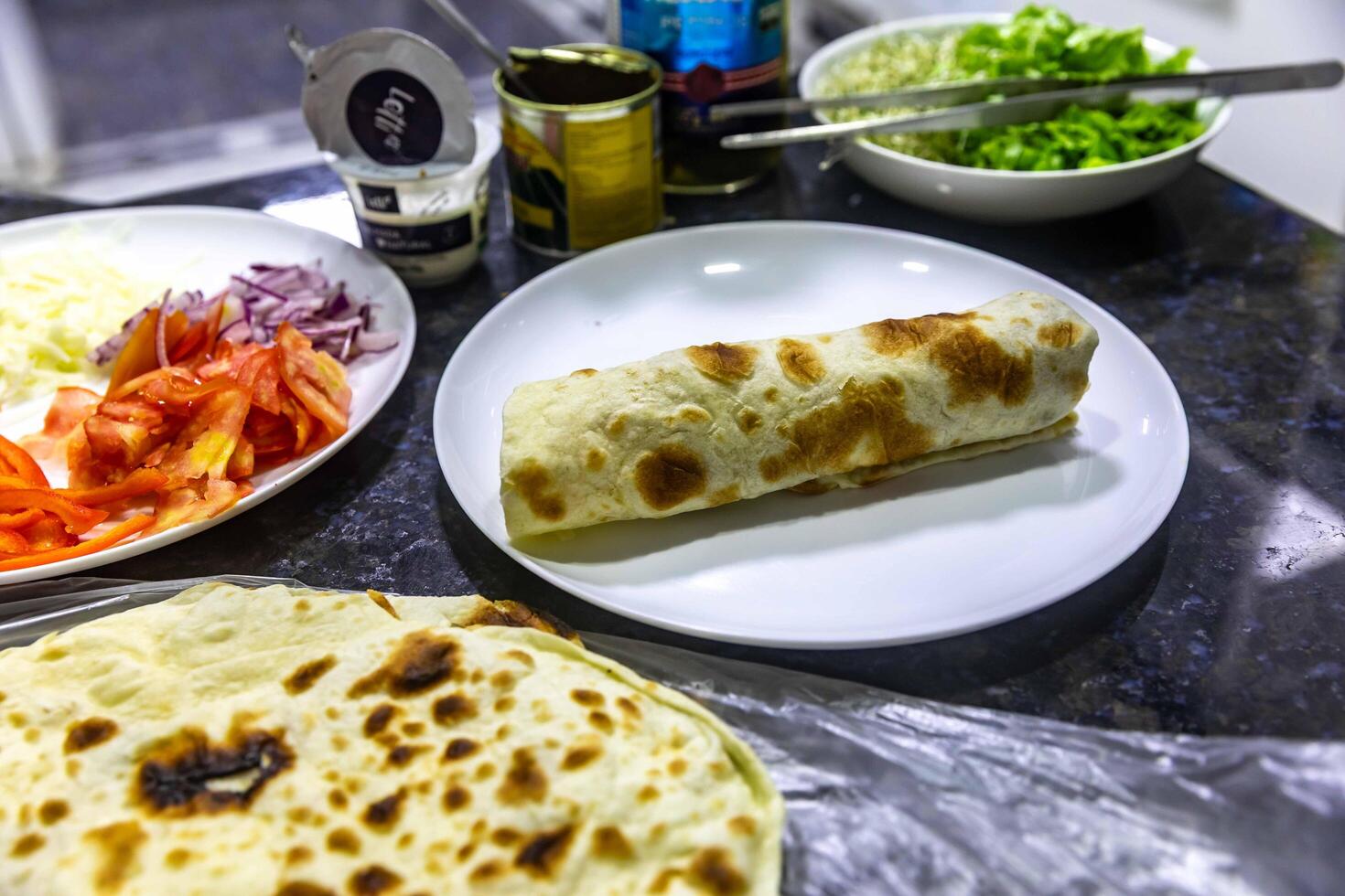The most traditional and classic shawarma prepared in Syrian bread or pita bread grilled on a stone perfect photo