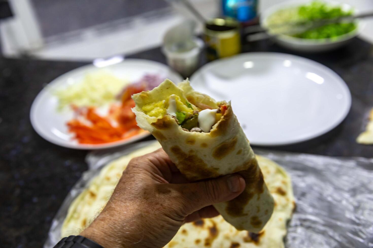 The most traditional and classic shawarma prepared in Syrian bread or pita bread grilled on a stone photo