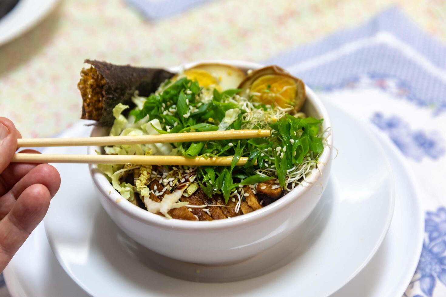 Traditional Japanese ramen or ramen with vegetable broth, grilled pork, oriental noodles and classic Japanese cuisine spices top view photo