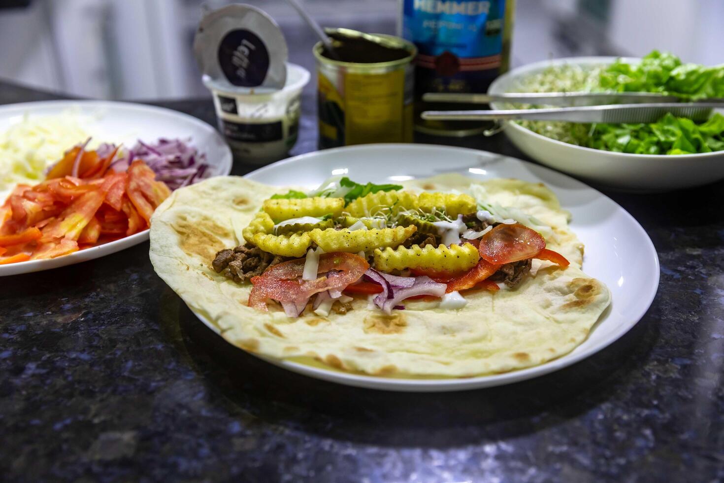 The most traditional and classic shawarma prepared in Syrian bread or pita bread grilled on a stone portrait photo