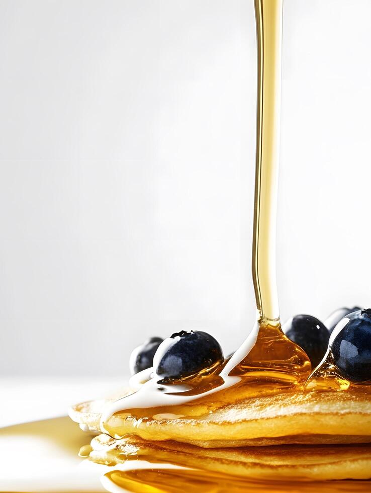 Pancakes with syrup being poured over them photo