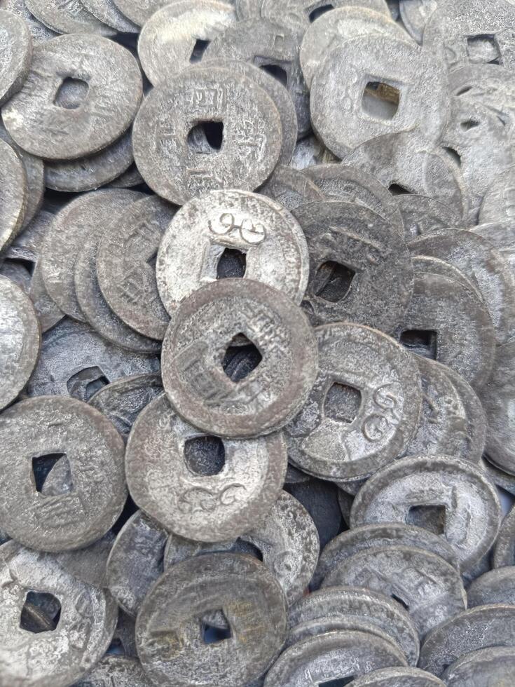 Ancient Chinese money. This money was used by Chinese traders as a means of exchange in ancient times, and has now become a tool for Hindu religious ceremonies in Bali. Money with holes photo