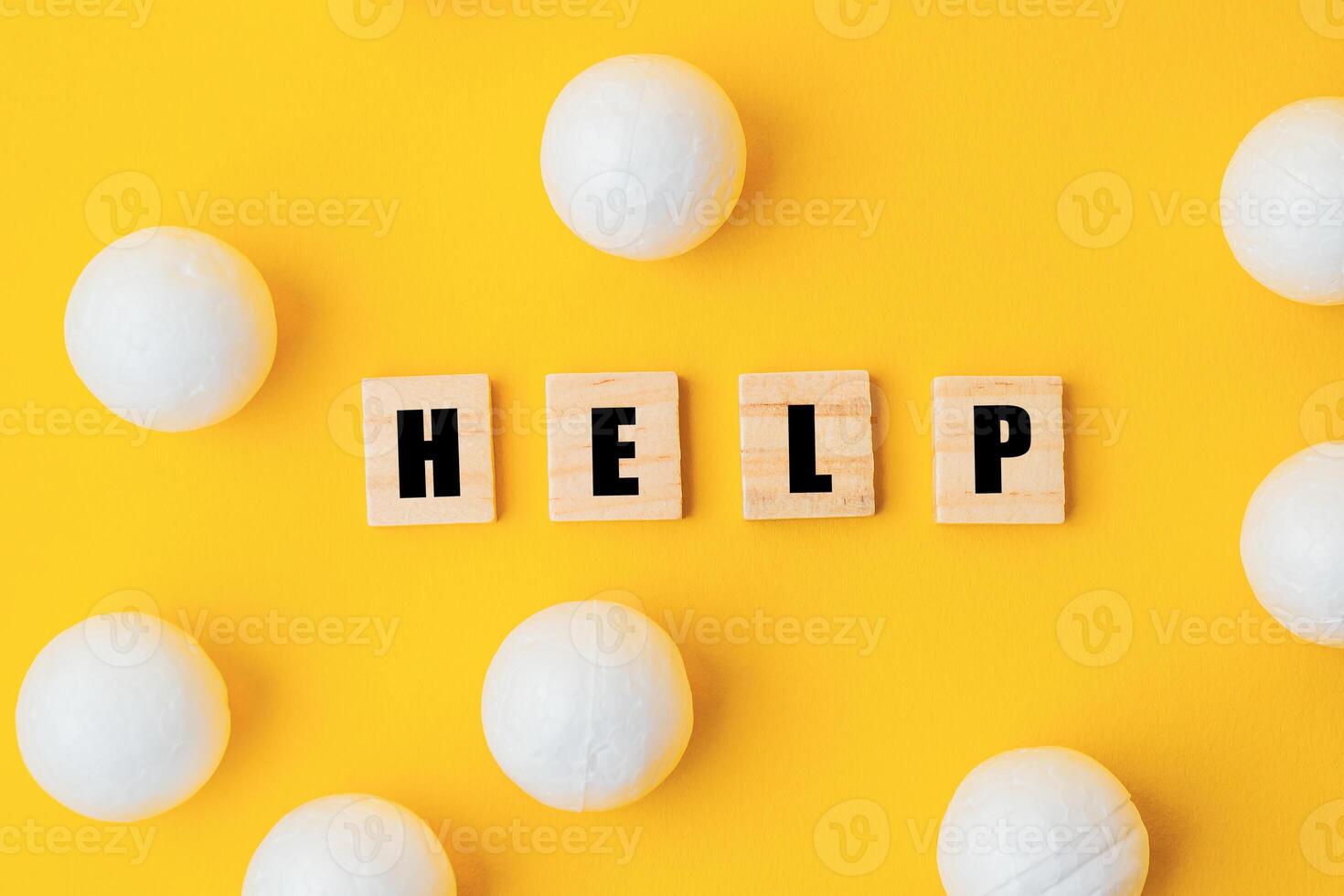 A yellow background with a large group of white balls scattered around it photo