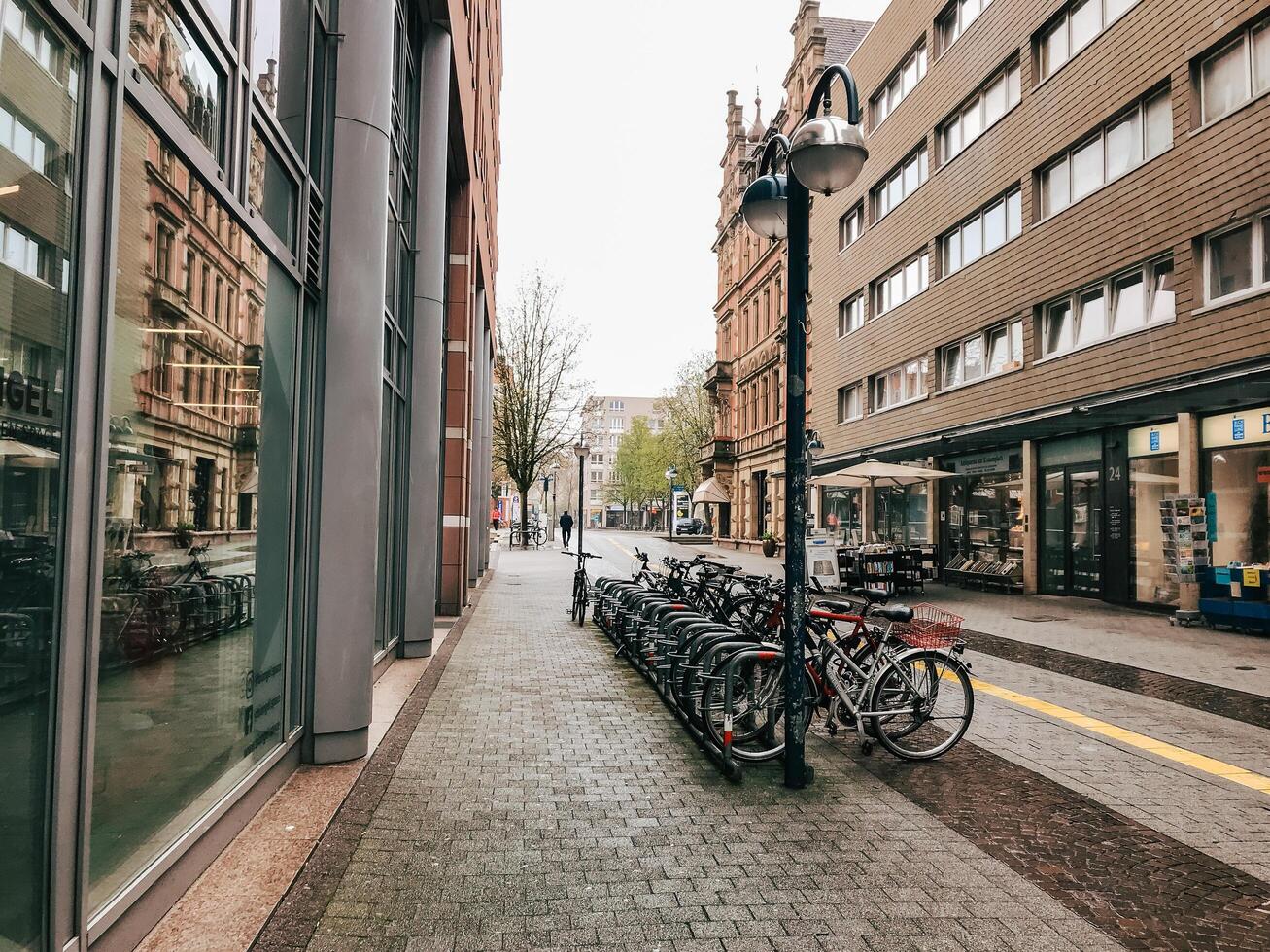 Karlsruhe, Germany March 25, 2022 A street with a lot of bikes parked on the sidewalk photo