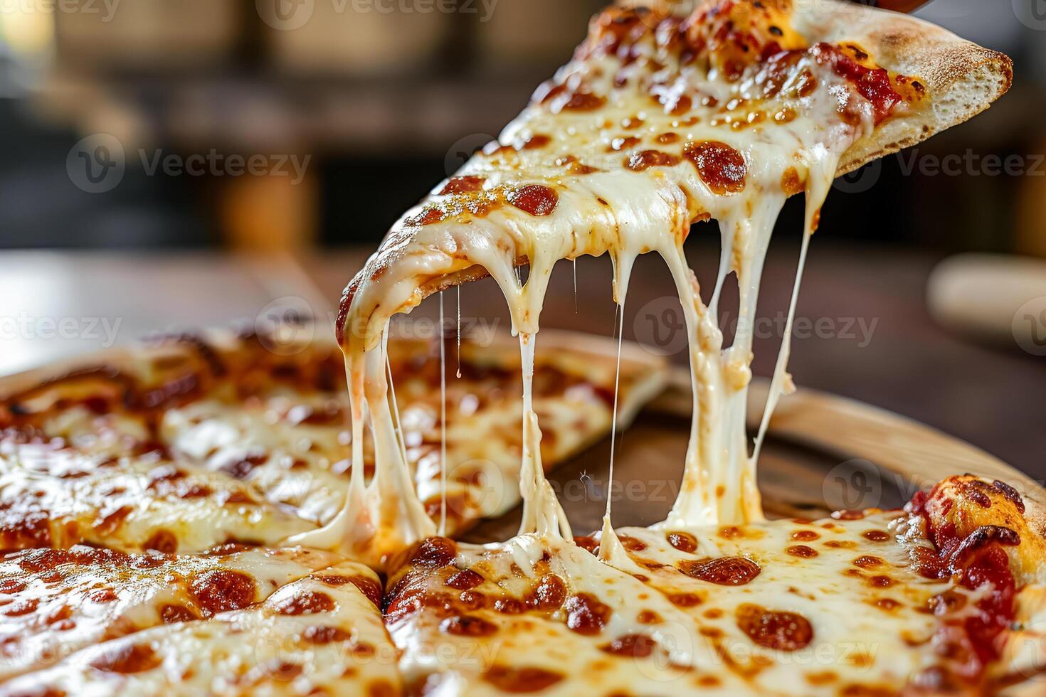 Perfect pizza slice with melted cheese being lifted photo