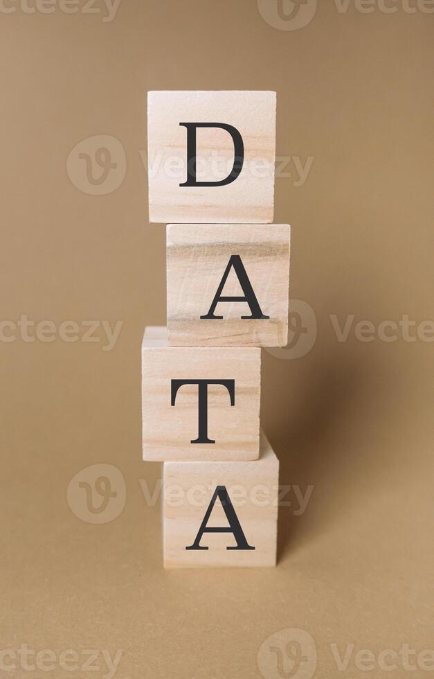 Stack of wooden blocks with the letters DATA on top photo