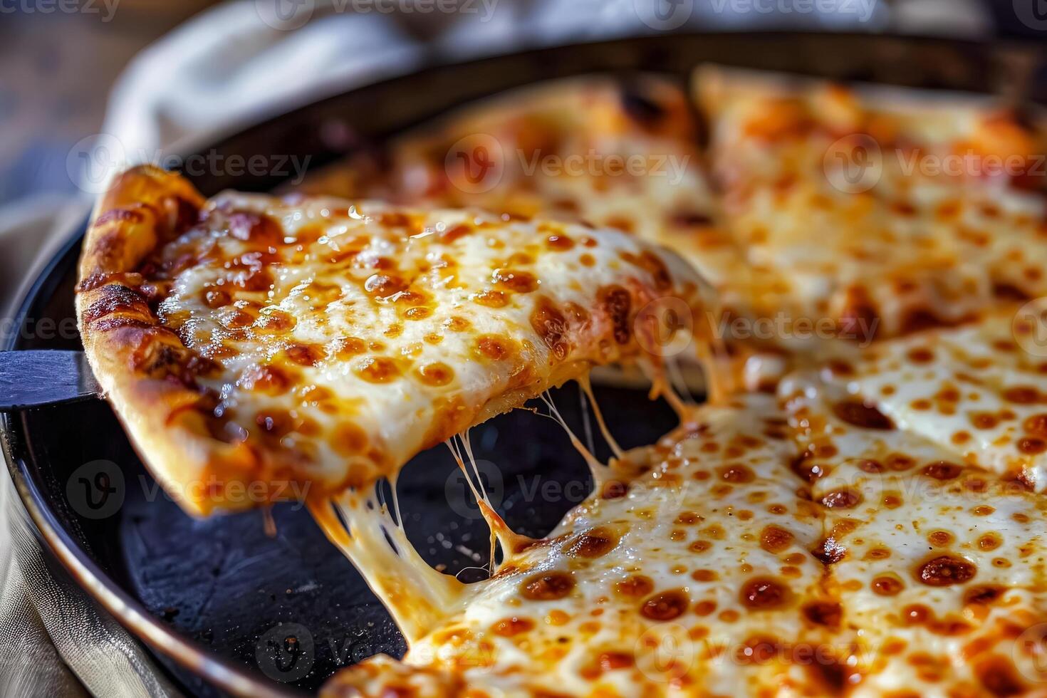 Hot pizza slice with melted cheese being lifted photo