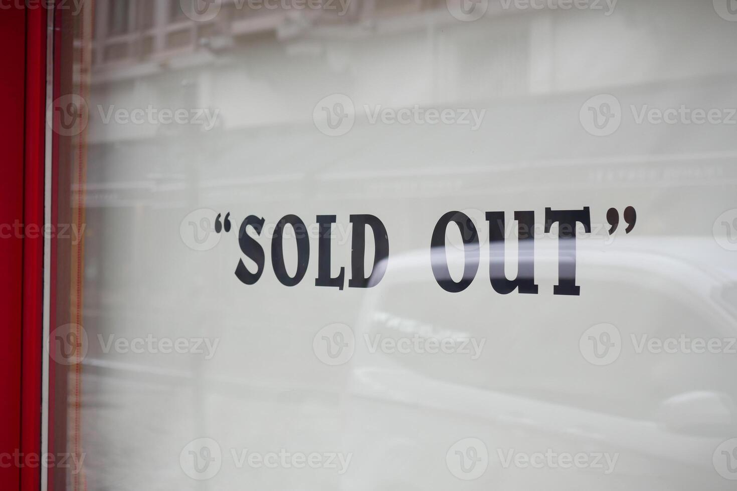 Shop display shows sold out sign on window photo