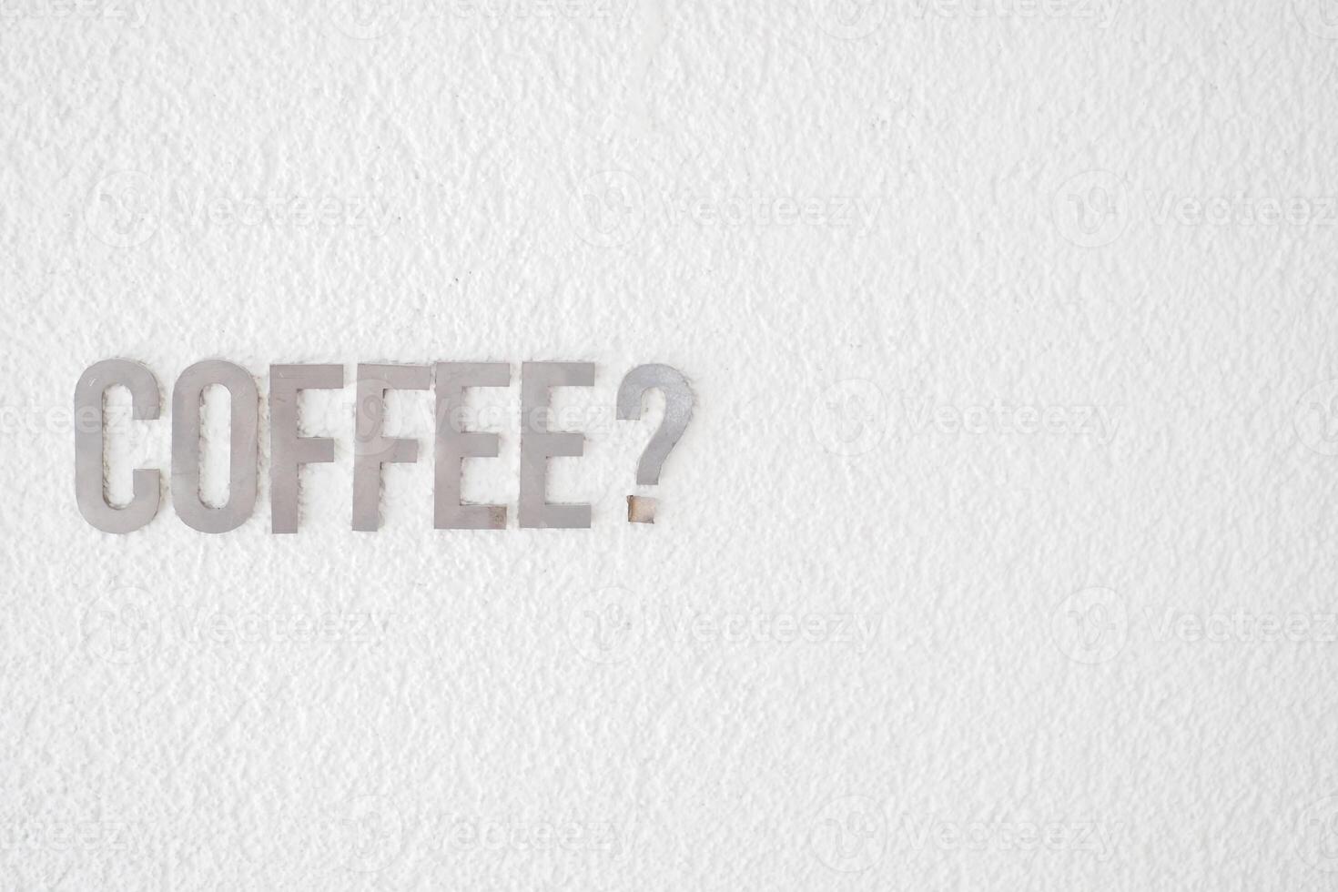 Coffee sign on a white wall in a cafe setting photo