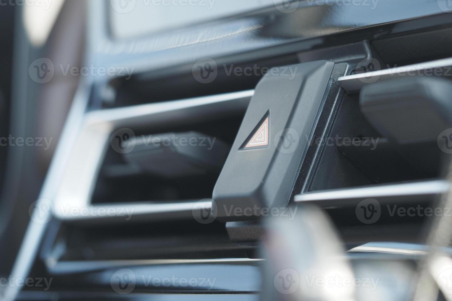 Car dashboard with air vent and hazard button detail photo