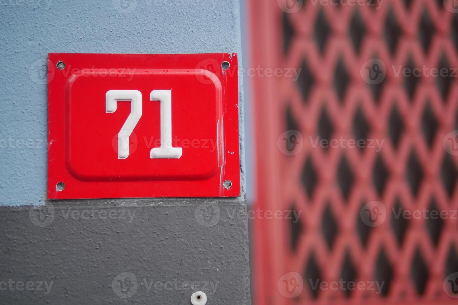 Number 71 on a building facade with distinctive color palette photo