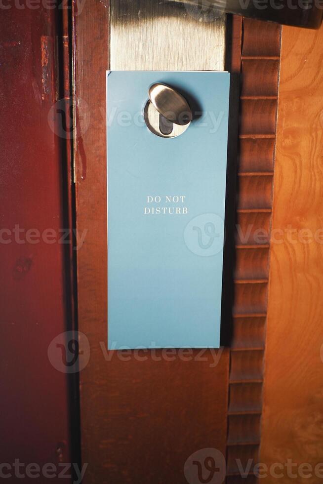 Hotel door hanger with do not disturb sign during daytime photo