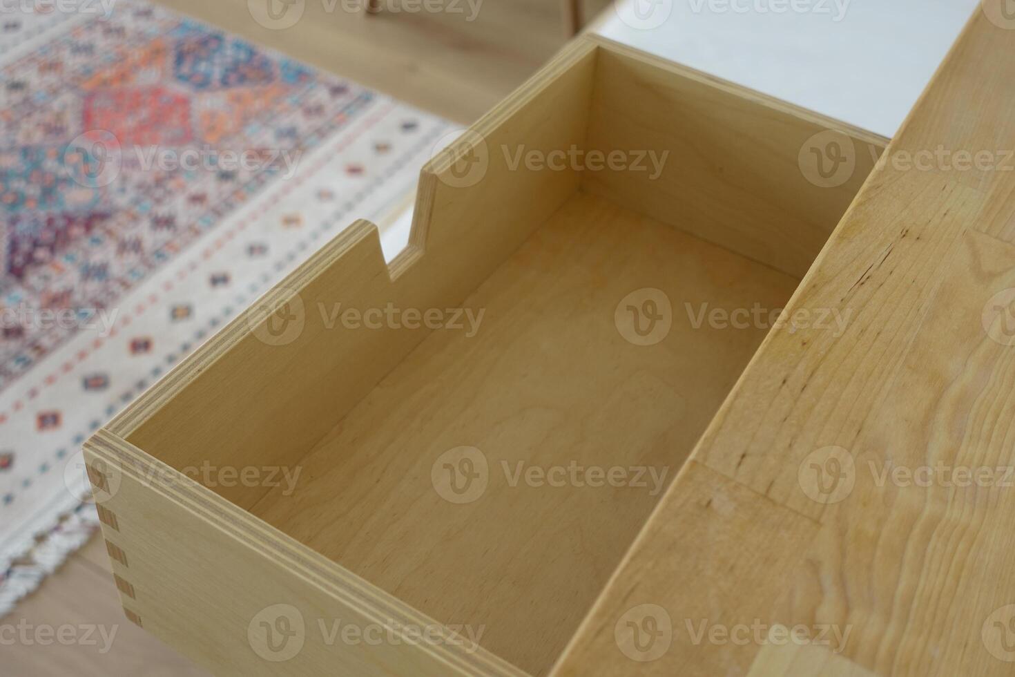 Wooden drawer with an empty space in a modern interior setting photo