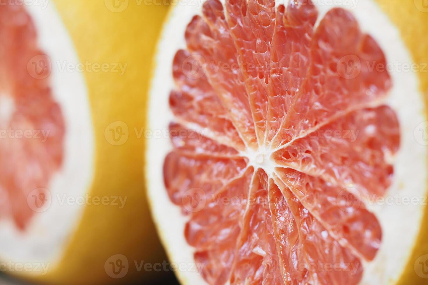 Freshly cut pink grapefruit showing juicy segments and texture photo