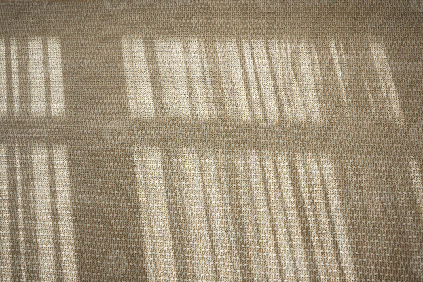 Light patterns creating shadows on a textured surface in the afternoon photo