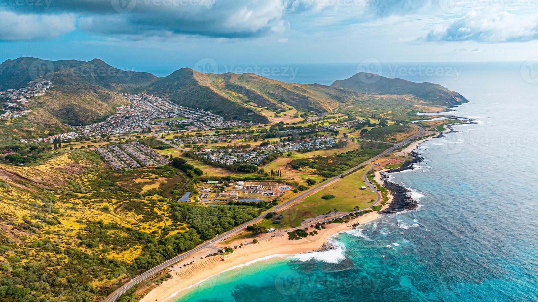 Ocean meeting the land. Bare rocks at the coast curved by the waves. Shore of Oahu, Hawaii, USA photo