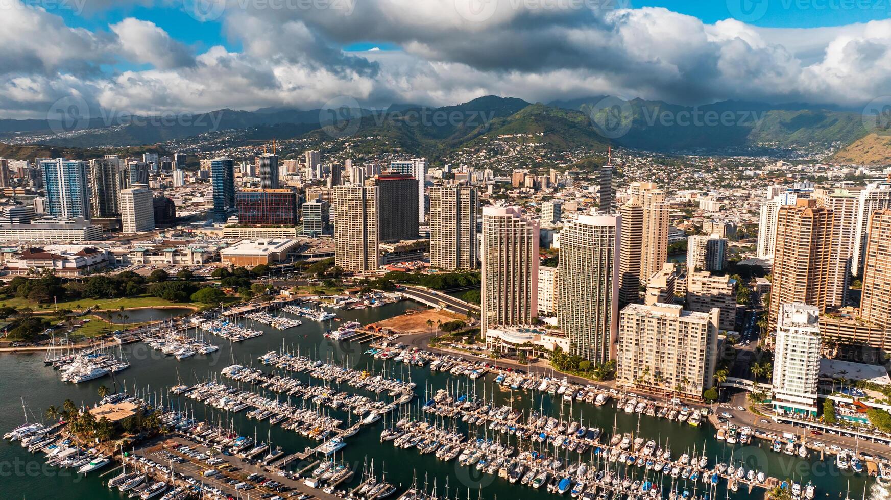 Multiple yachts stand on the anchor at the piers. Approaching the shore of Honolulu, Hawaii, USA from above the Pacific Ocean. photo