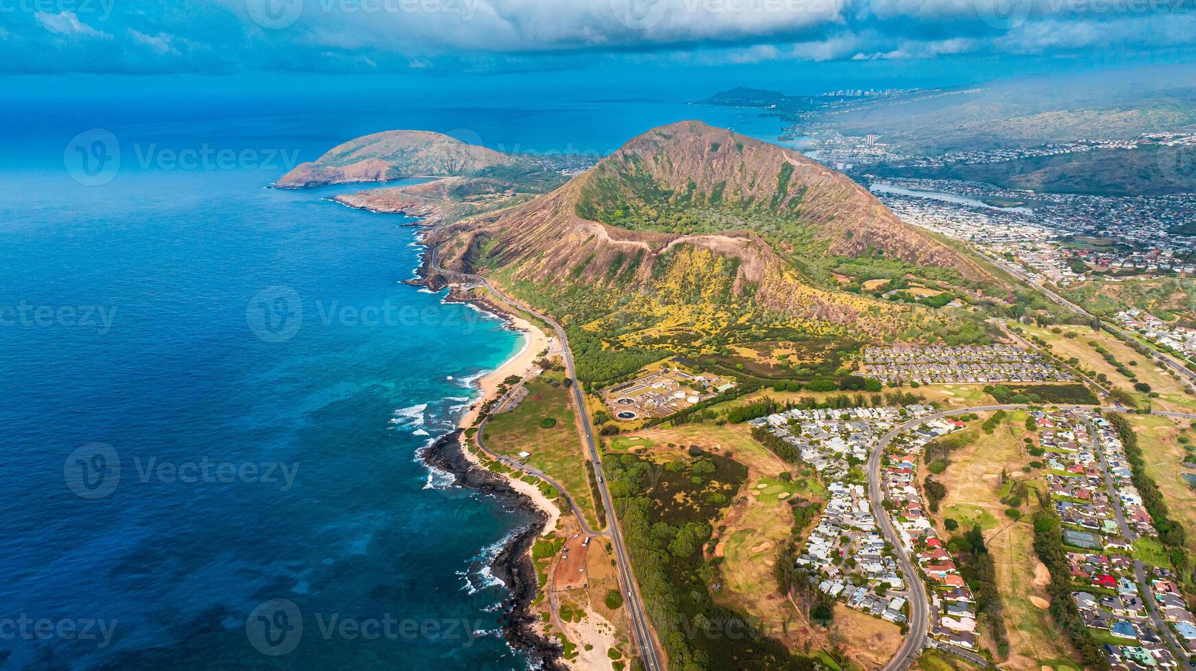 Ocean meeting the land. Bare rocks at the coast curved by the waves. Shore of Oahu, Hawaii, USA. Aerial view photo