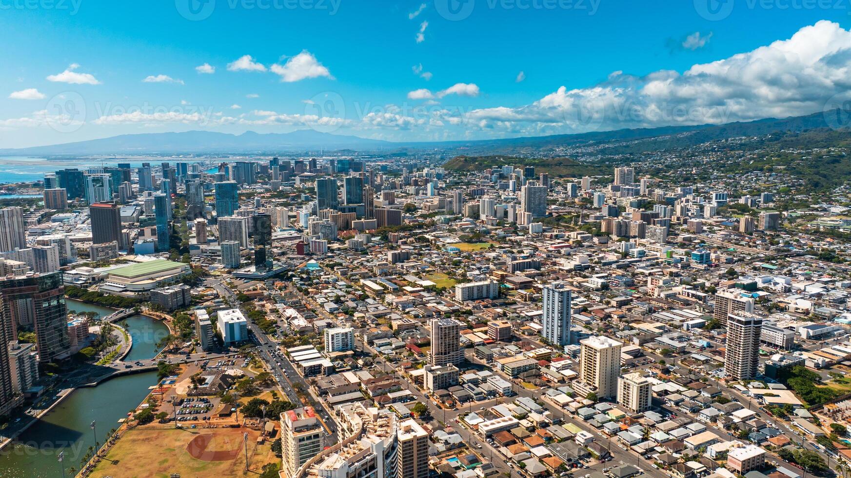 Varied urban landscape of densely-built Honolulu, Hawaii, USA. Aerial perspective eon the city under the grey cloudy sky photo