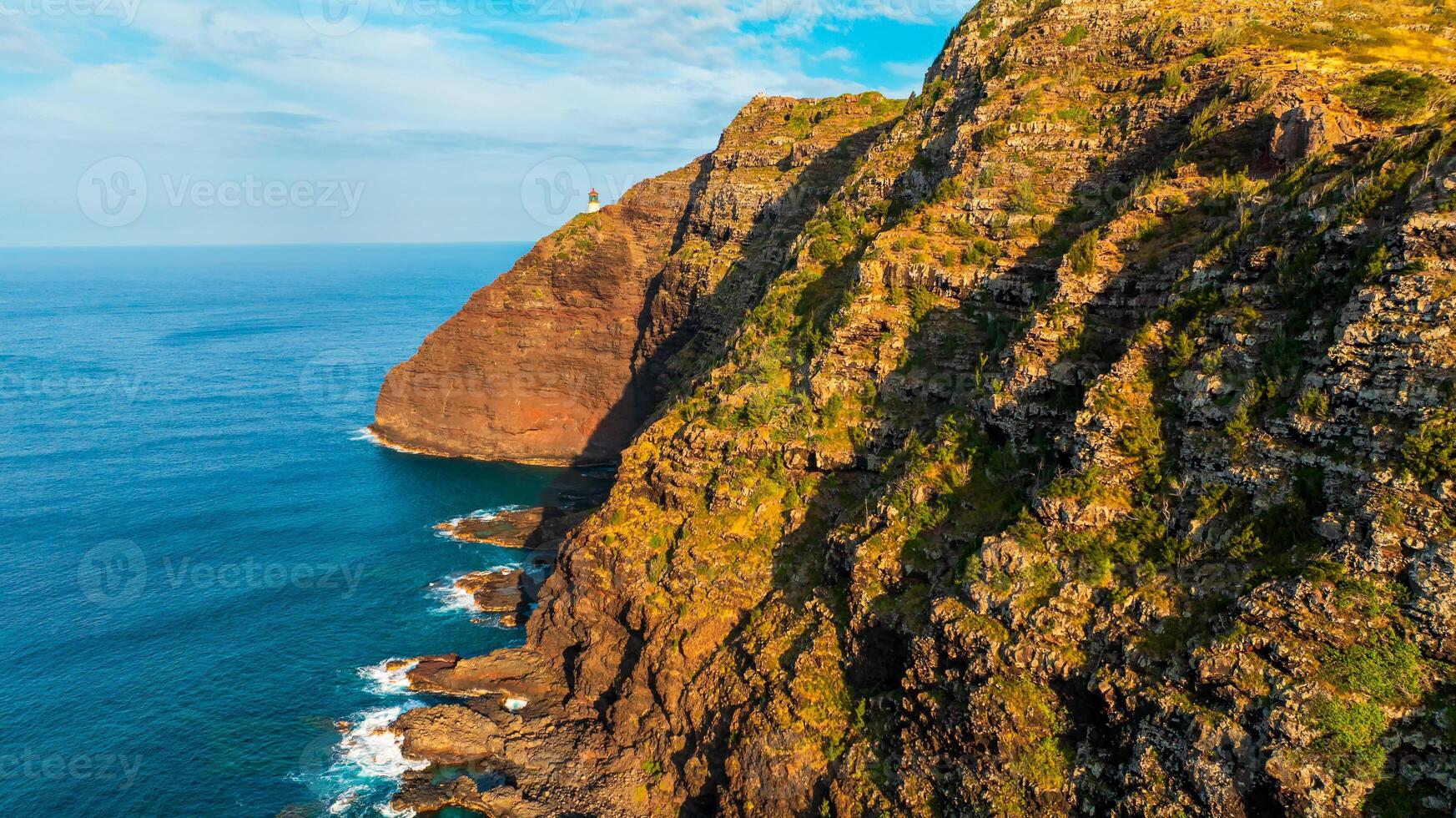 Stunning unapproachable rocks descending into the ocean. photo