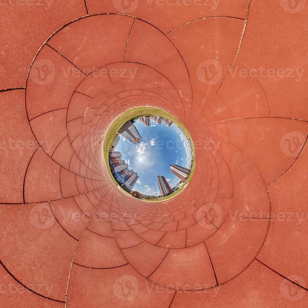 A circular view of a city skyline from inside a circular tunnel photo