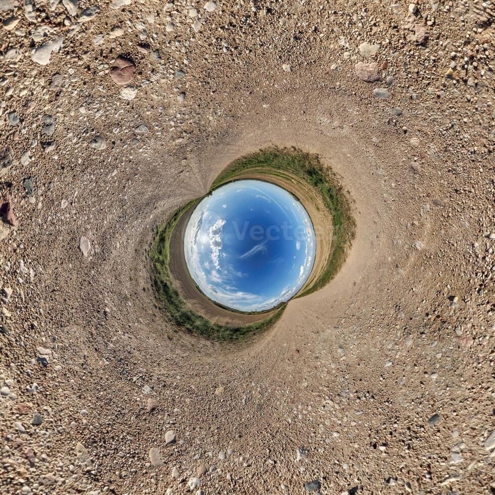 A view of a blue sky from inside a circular hole photo