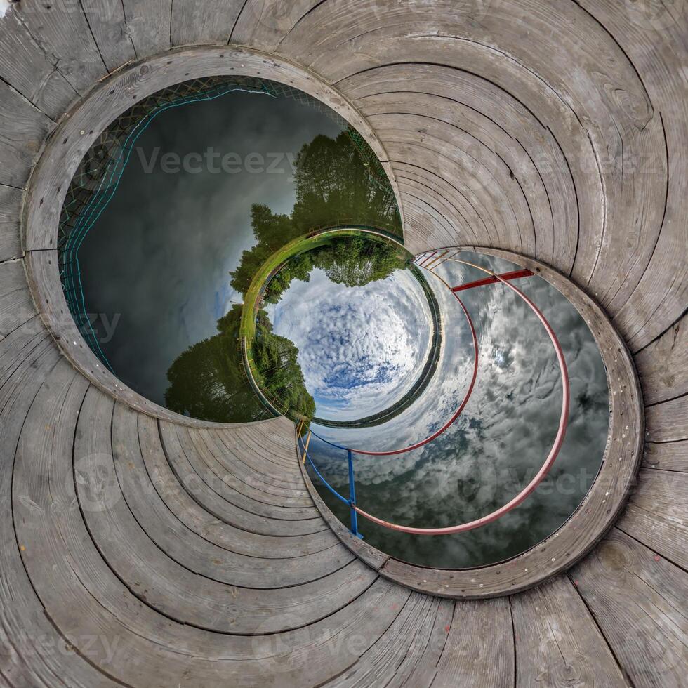 A circular hole with a view of a lake and sky photo