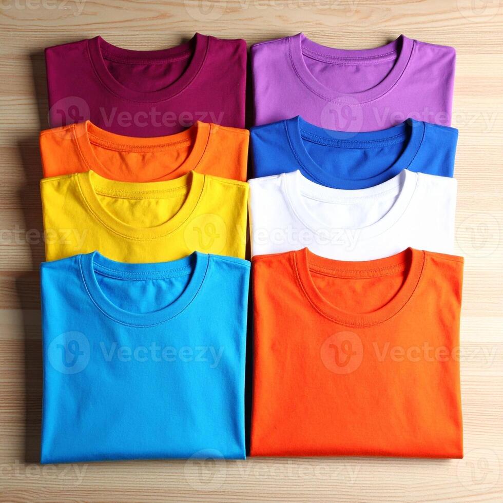 Stack of Vibrant Cotton T-Shirts in Multiple Colors on Wood Table photo