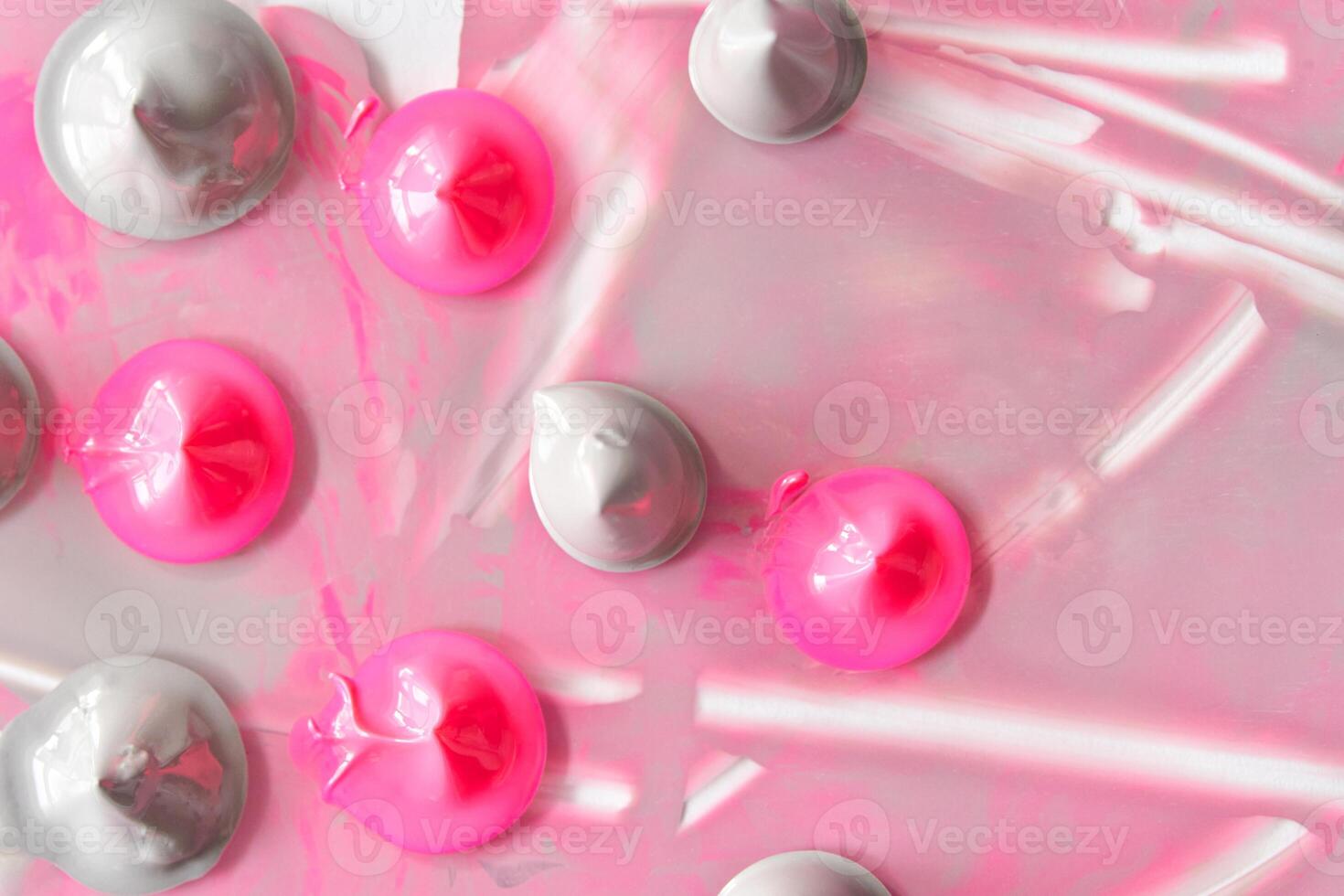 Abstract pink and gray paint blobs on canvas creating a unique textured art design. photo