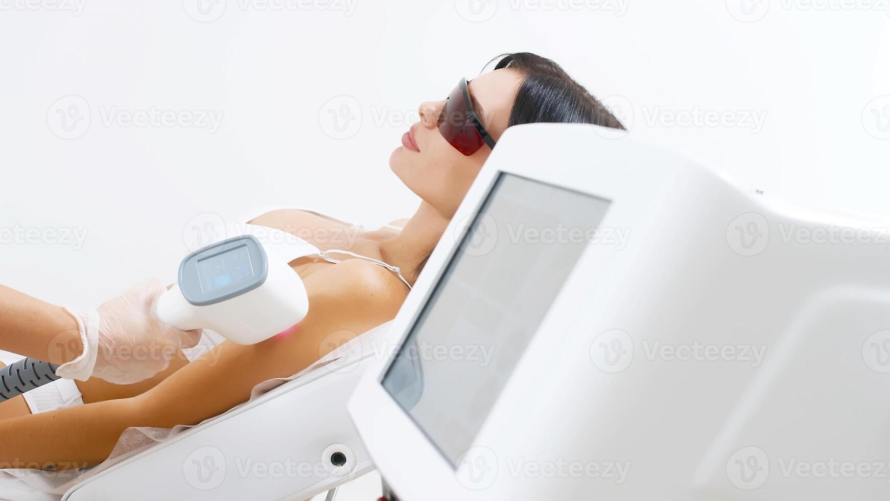 Laser epilation, hair removal procedure, young beautiful caucasian smiling brunette woman against white background, armpits epilation, spa and cosmetology concept. Advertising photo